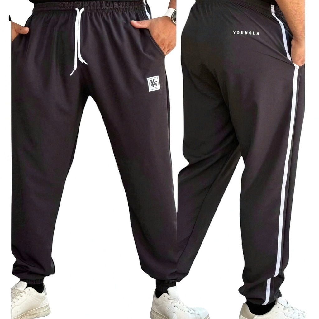 DUALLITY WEAR black joggers with white sideline stripe, drawstring waist, and modern fit. Comfortable and durable fabric.