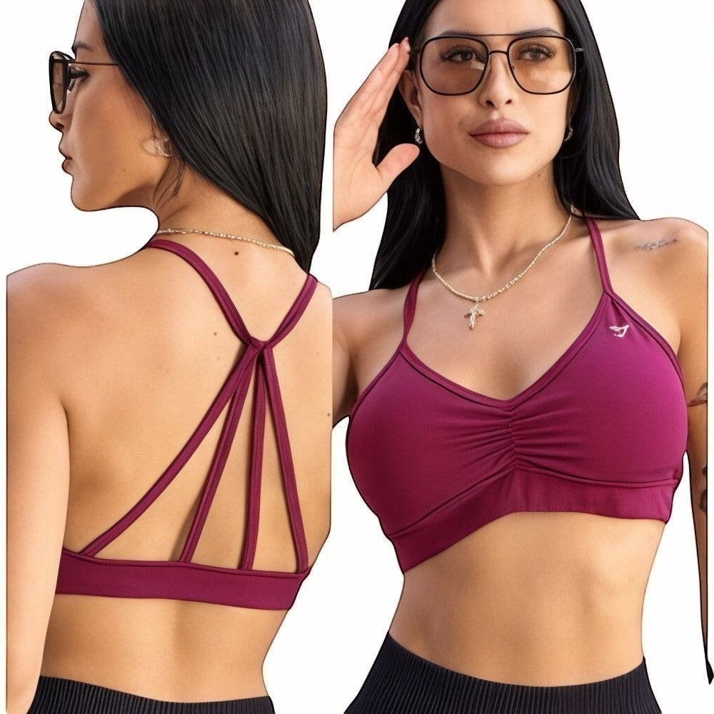 DUALLITY WEAR burgundy sports bra with ruched front and strappy back, made of lightweight stretch fabric for gym or daily wear.