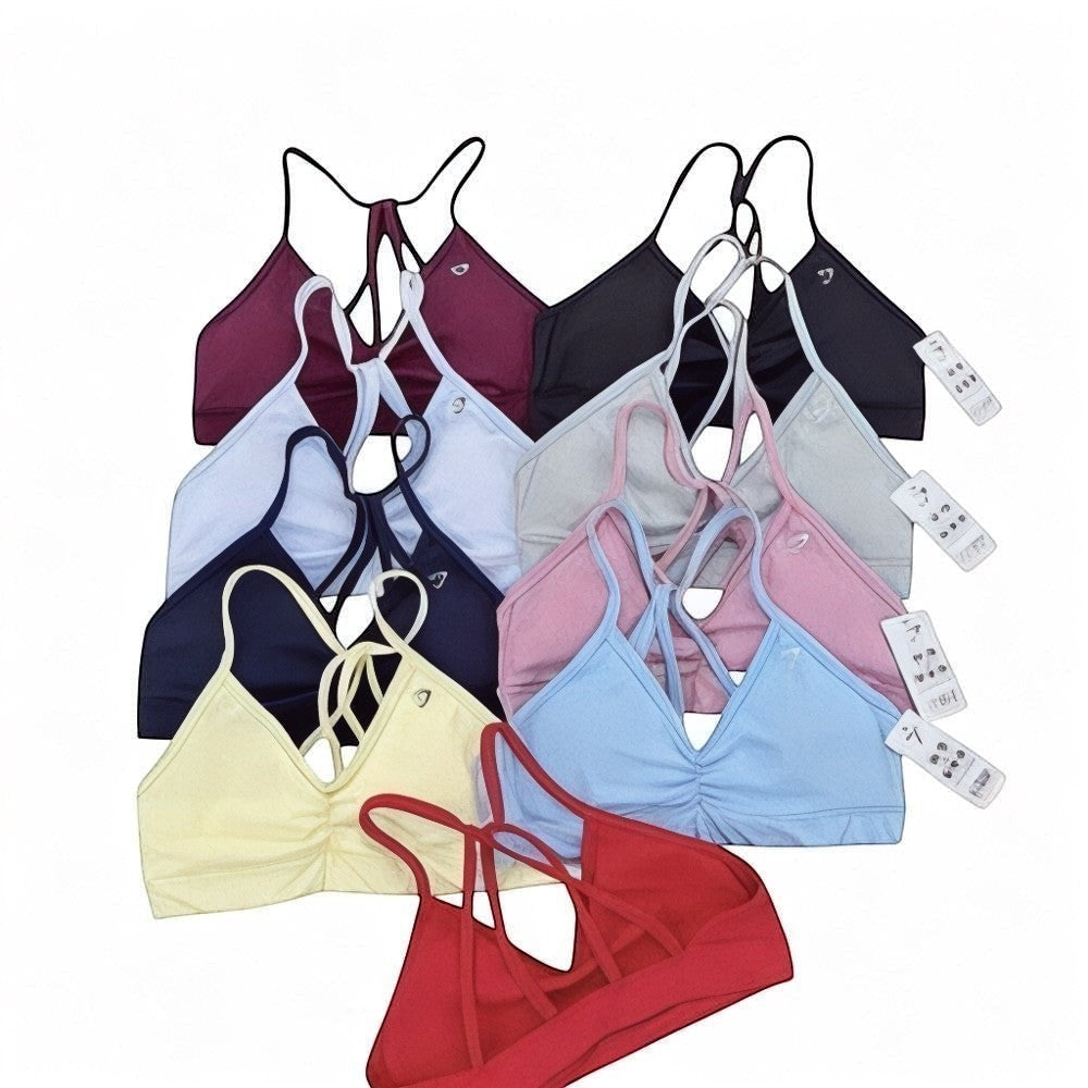 DUALLITY WEAR collection of minimal sports bras in various colors: red, yellow, navy, light blue, pink, grey, white, burgundy, and black. Features ruched front and strappy back.