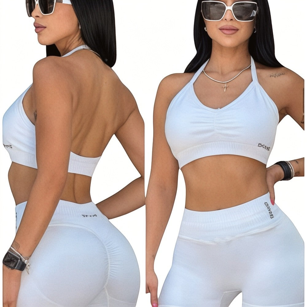 DUALLITY WEAR white ruched halter neck sports bra with strappy back detail and matching high-waisted shorts.